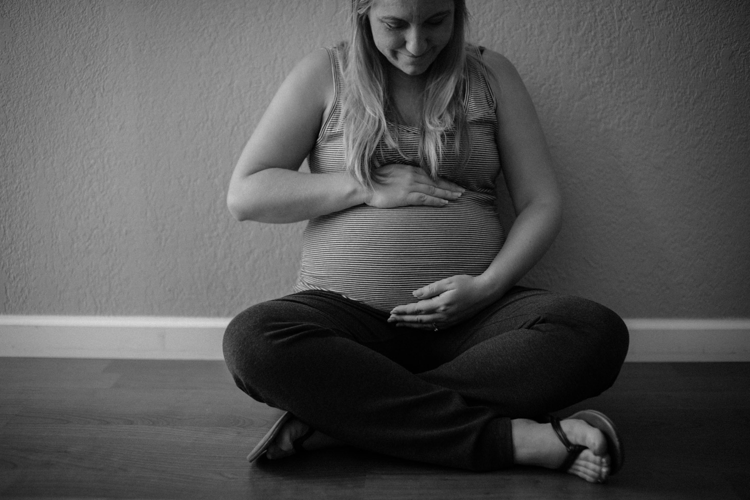 Pregnant mother sitting on floor.